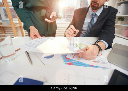 Cropped portrait of two business people discussing documents over meeting table, copy space Stock Photo