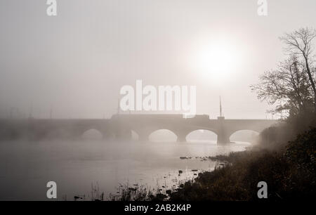 Dresden, Germany. 25th Nov, 2019. In the morning an S-Bahn travels in the fog over the Marienbrücke bridge over the Elbe. Credit: Robert Michael/dpa-Zentralbild/dpa/Alamy Live News Stock Photo