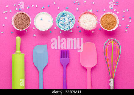 ingredients for baking and kitchen tools on pink background, flat lay Stock Photo