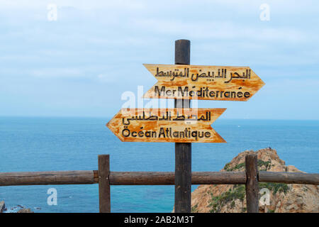 Signs indicating the place where the Atlantic ocean joins the Mediterranean sea near Tangier, Morocco
