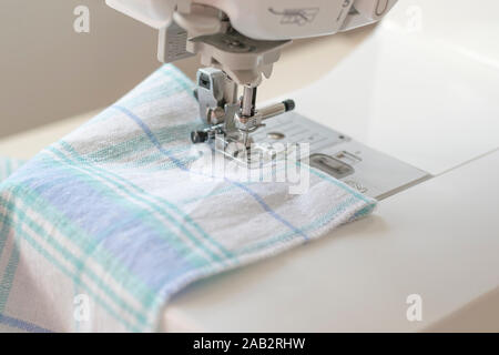 Sewing machine part, fabric, threads and accessories for sewing close-up. Stock Photo