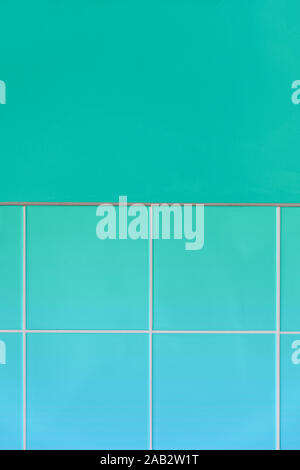 Wall with ceramic tiles in a neo mint green colored effect background. White lines in between the tiles. Light blue gradient. Simple geometric style. Stock Photo