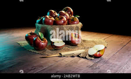half cut red apples and whole apples in bowl with wood fabric with knife Stock Photo