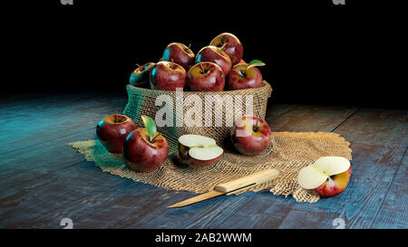 Fresh whole and half cut apples in a bowl on wooded table with knife . Stock Photo