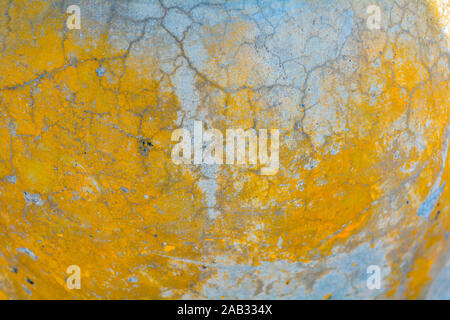Yellow and gray cracked concrete texture. Rough surface with yellow painted spots. Old weathered painted background texture Stock Photo