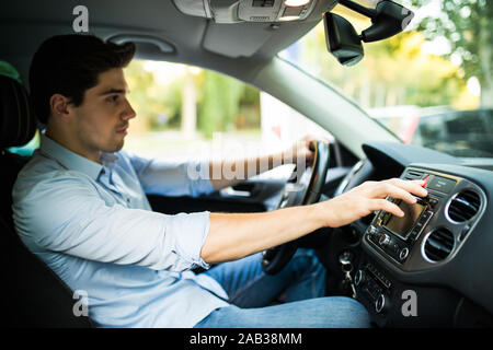 presses the emergency stop button in the car Stock Photo