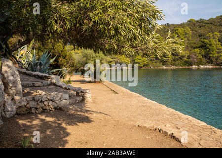 Surrounding view from the small island of Saint Mary at Mljet, the beautiful salt water lakes and the National Park. Calm and peaceful path in nature. Stock Photo