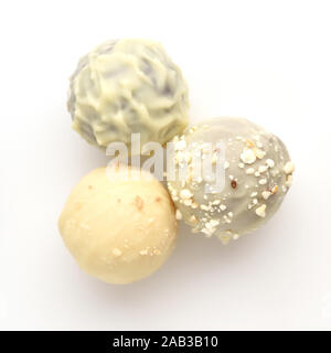 Three candies of white chocolate on white background. Top view. Stock Photo