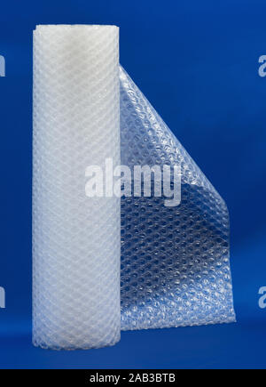 Packaging bubble wrap roll on blue color background Stock Photo