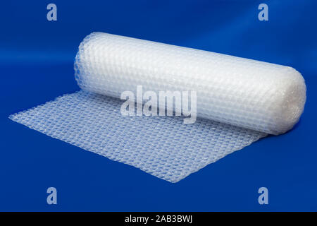 Packaging bubble wrap roll on blue color background Stock Photo