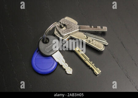 Bunch of keys on a black wooden table Stock Photo