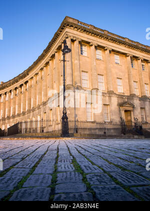 Royal Crescent in Bath, England with foreground cobbled street. Stock Photo