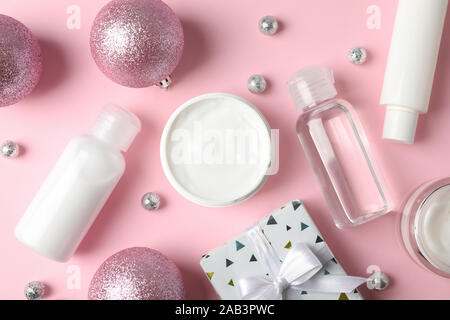 Set cosmetics, winter cream for skin, gift box on pink background, closeup. Top view Stock Photo