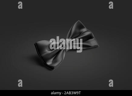 Blank black classic bow tie mockup lying on dark background Stock Photo