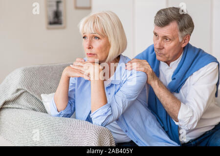 Relationship problems. Senior man consoling wife after quarrel Stock Photo