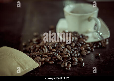 Hot Black coffee in glass and Arabia coffee beans on the table Stock Photo