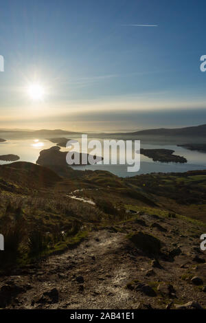 Looking down the muddy trail leading to the top of Conic Hill part of the iconic West Highland Way Scotland's oldest long distance walking trail Stock Photo