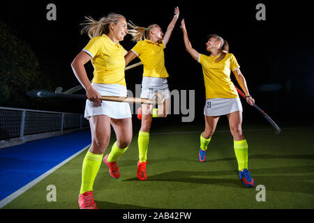 Group of female field hockey players celebrate the victory Stock Photo
