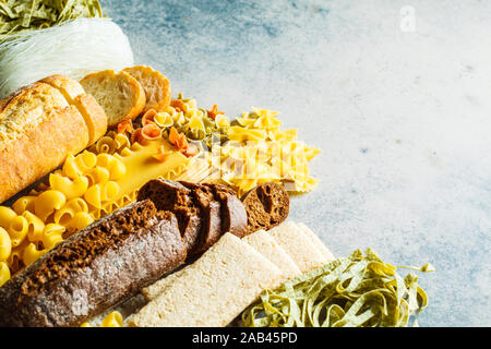 Various pasta background. Bread and different pasta on a gray-blue background, copy space. Stock Photo
