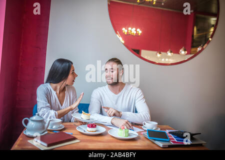 Businessmen feeling not satisfied with dessert while having quality check Stock Photo