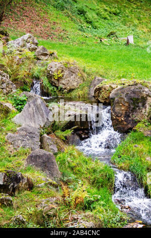 a small Waterfall, cascade, an artificial watercourse in the form of steps in the mountains of Austria Stock Photo