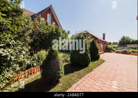 Russia, Moscow- July 06, 2019: beautiful designer country house with wooden elements. beautiful landscaping Stock Photo