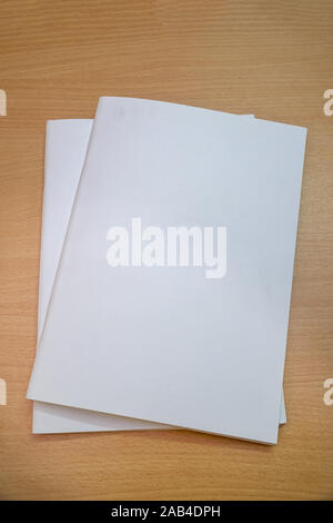 Blank brochure form with a clear title page for your project on a wooden table Stock Photo