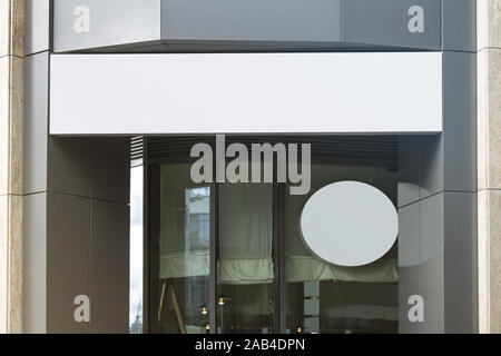 Blank white rectangular and round sign on business center mockup Stock Photo