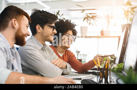 Millennial programmers coding new program on computer at office Stock Photo