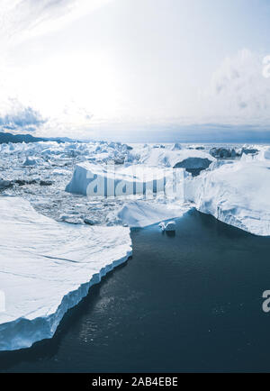 Iceberg and ice from glacier in arctic nature landscape in Ilulissat,Greenland. Aerial drone photo of icebergs in Ilulissat icefjord. Affected by