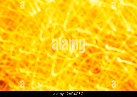 Futuristic blurred lights holiday monochrome background in yellow. Horizontal, soft focus Stock Photo