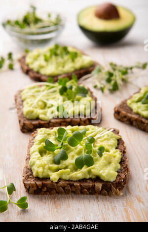 Whole grain sandwiches with avocado spread and microgreen Stock Photo