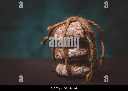 fresh gingerbread cookies tied with a rope on the table Stock Photo