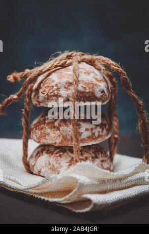 fresh gingerbread cookies tied with a rope on the table Stock Photo