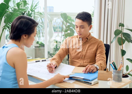 Two architects discussing about new project in the office Stock Photo