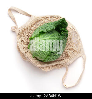 Fresh young cabbage in eco net shopping bag on white Stock Photo