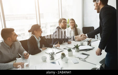 Members of commission congratulating applicant with job Stock Photo