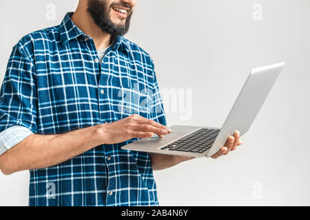 Mature bearded man using modern laptop computer Stock Photo