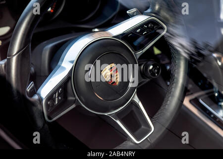Russia Kemerovo 2019-08-31 Interior salon of private car, Porsche Macan. Black steerwheel with logo Stock Photo