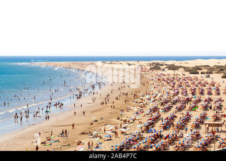 A lot of people in the famous beach 'Playa del Ingles' in Maspalomas, Canary Islands. White sky background for text. Stock Photo