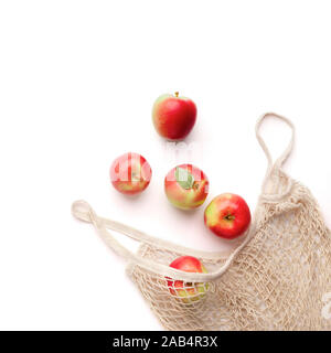 Fresh red apples in zero waste net bag on white background Stock Photo