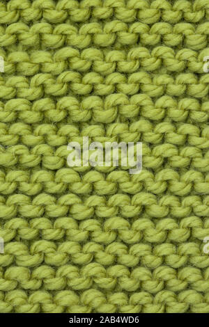 Knitting merino wool yarn green jumper, with close-up detail of a knit stitch Stock Photo