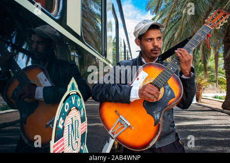 A local man plays guitar at the train station at Matjiesfontein, Rovos Rail train "Pride of Africa" on it's journey between Pretoria and Cape Town, So Stock Photo