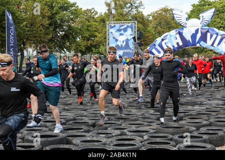 Though Viking participants running through tire obstacle course in Helsinki, Finland Stock Photo