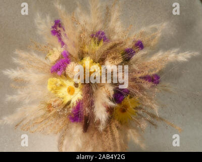 Dried flower and grass arrangement yellow and purple Stock Photo