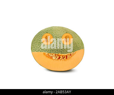 Emoticon carved out in cantaloupe melon, isolated on white background with copy space for text or images. Side view. Close-up shot. Stock Photo