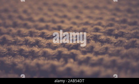 Knitted texture, brown thread pattern, cozy winter background. Stock Photo