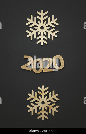 2020 winter holidays background.Black poster template with wooden figures and snowflakes shot in flat lay style from above.Vertical wallpaper for New Stock Photo