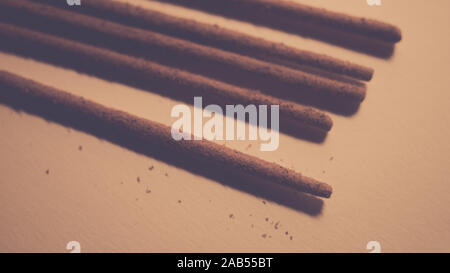 Natural sandalwood incense sticks and pollen from them on the table. Stock Photo