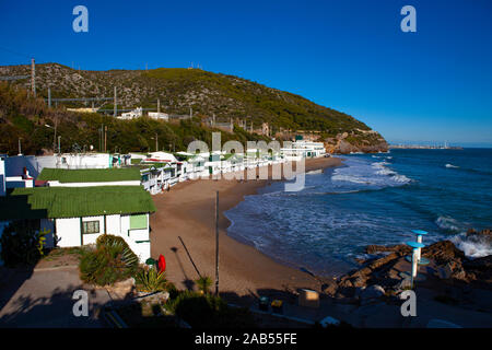 Platja de Les Casetes del Garraf, Garraf, Barcelona, Catalonia. These distinctive small green and white beach houses are in the beach village of Garra Stock Photo